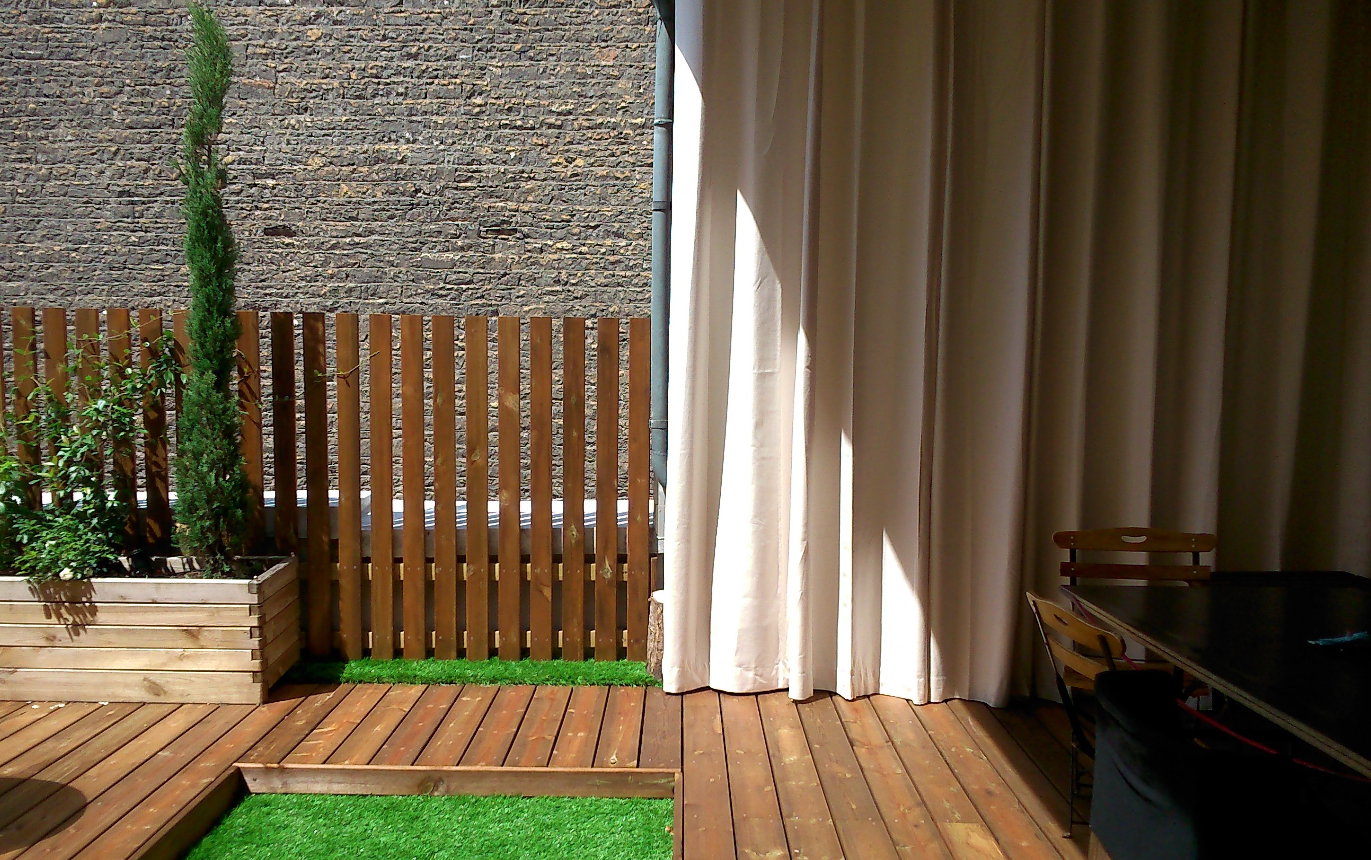 Rideau d'extérieur sur une terrasse rénovée par Exonido